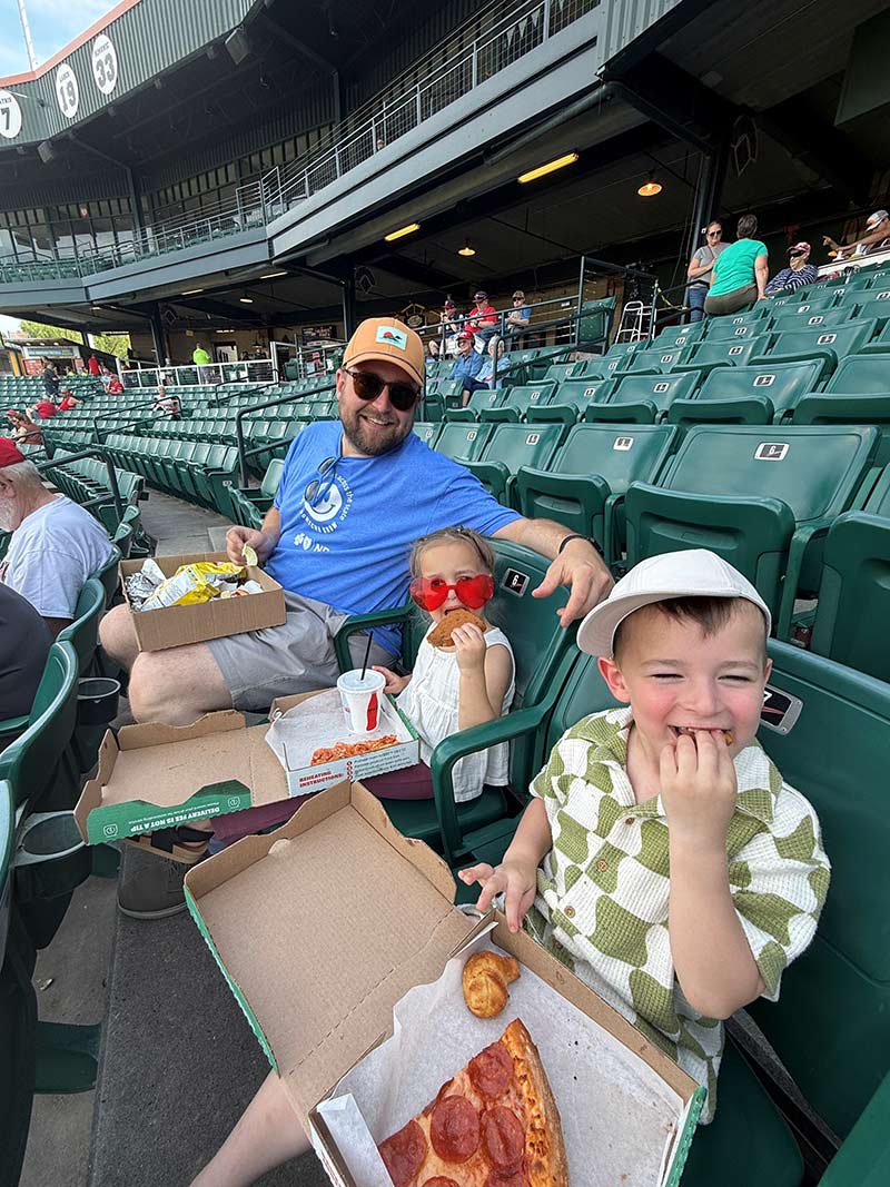 Cale Homuth and kids at a Redhawks baseball game