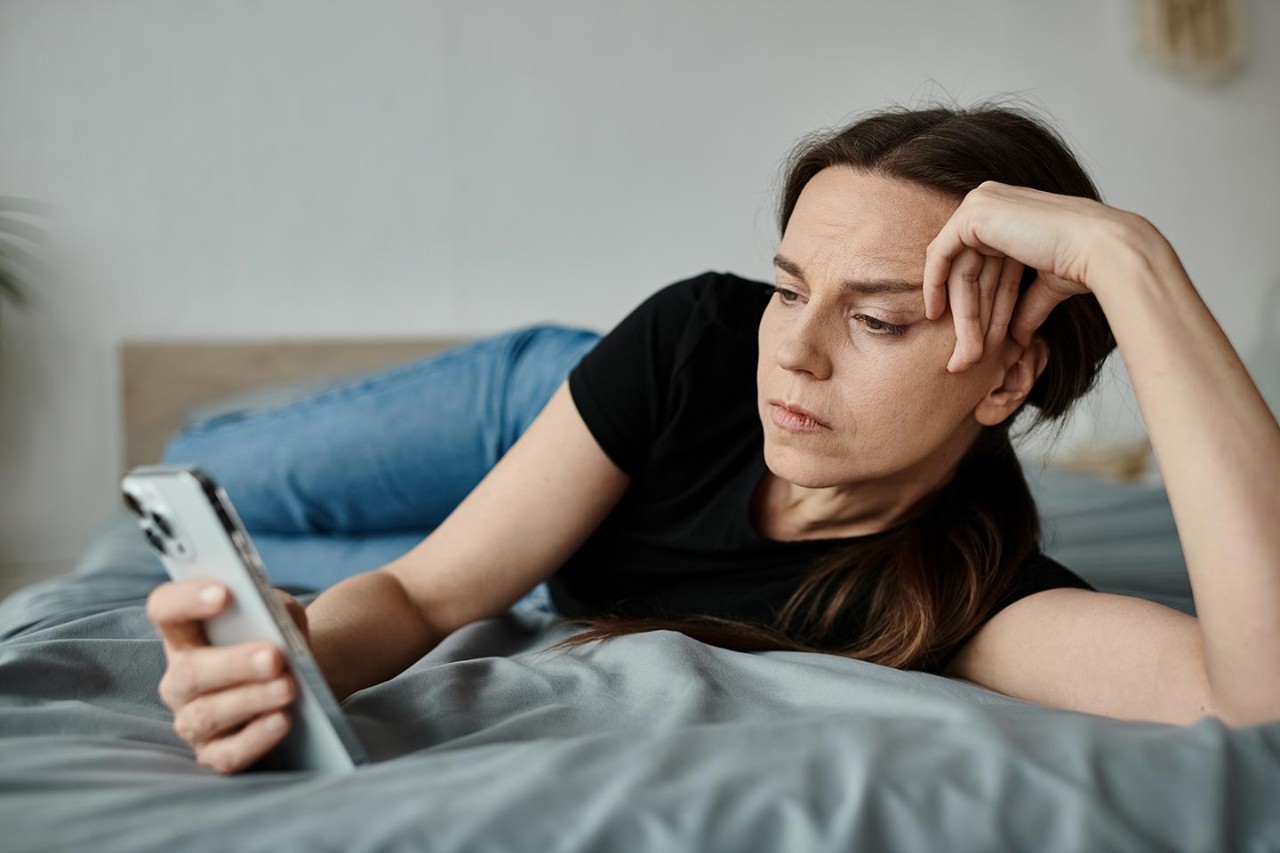 Middle aged woman looking at mobile phone